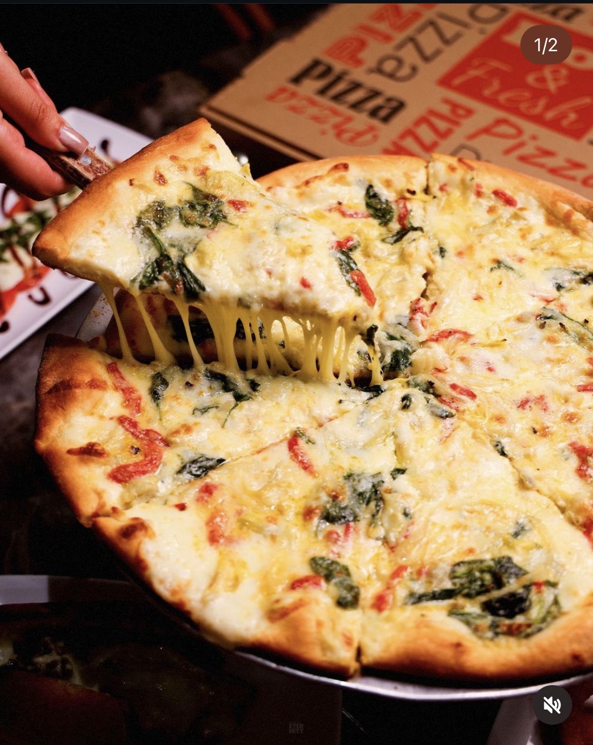 White pizza with spinach, artichoke, and roasted tomato